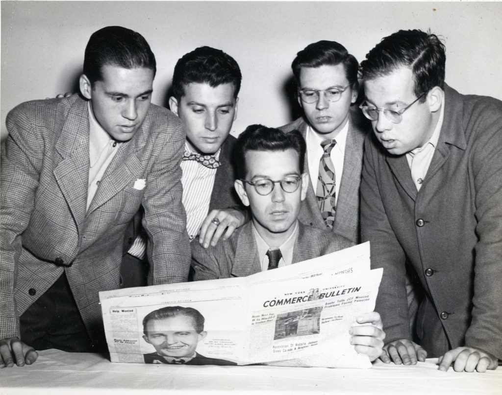 White men reading newspaper