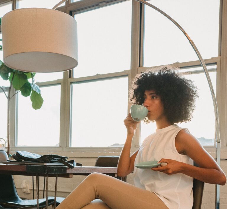 Woman drinking coffee at work